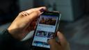 Jesenia De Moya Correa scrolls through Facebook on her phone while at work at the Philadelphia Media Network office on Monday, Nov. 19, 2018. 