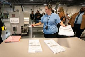 Philadelphia Election Clerk Lisa Gogel demonstrates a ballot scanner that will be used in the 2022 election in Pennsylvania.