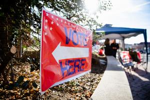 A sign directing people to "vote here" is seen in Camp Hill, Pennsylvania on midterm Election Day 2022.